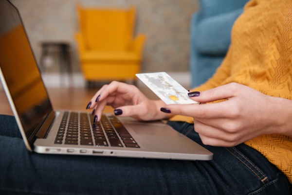 close-up-of-a-woman-buying-online-with-bank-card-PBHM4EP-scaled-1